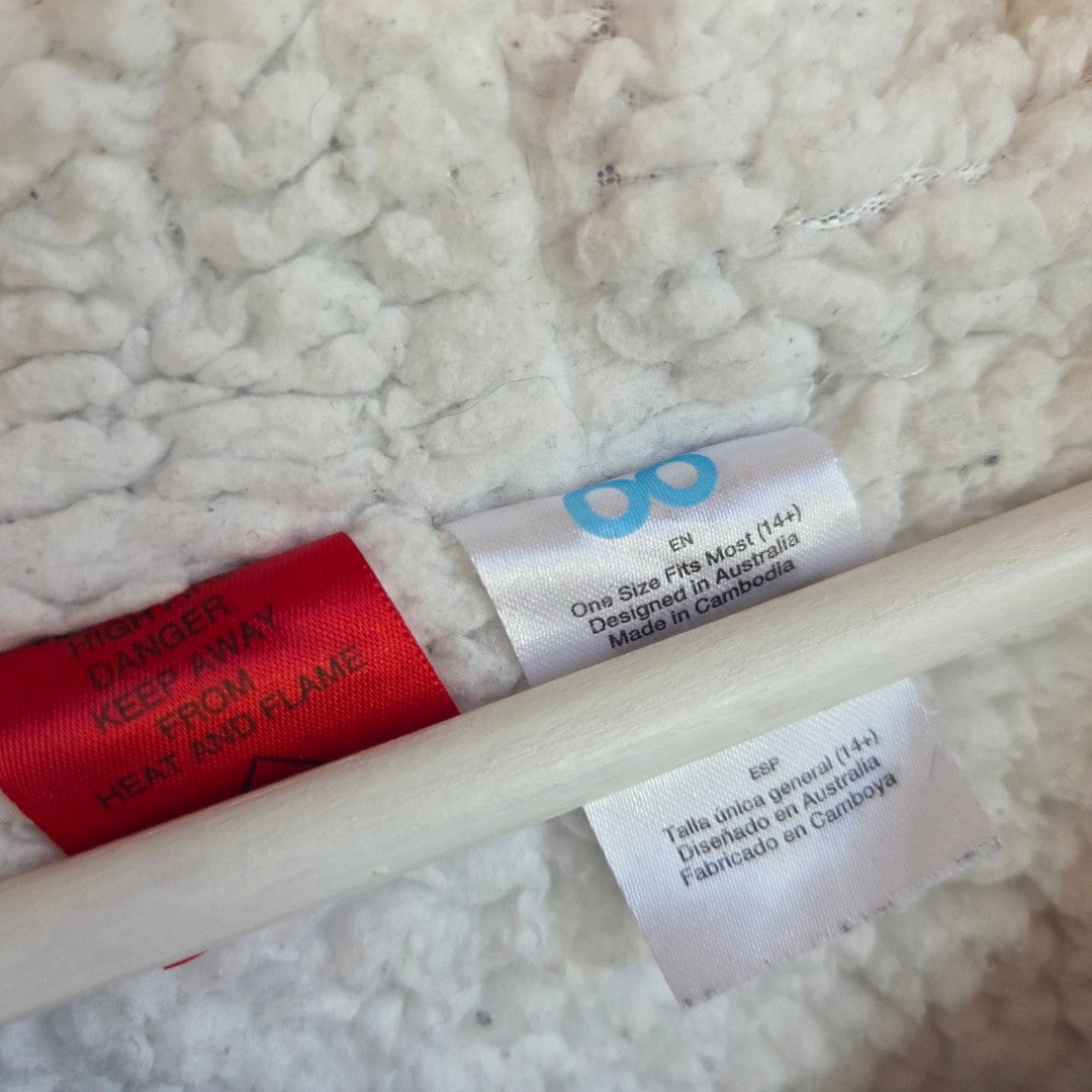 Clothing labels stitched into the white fleece lining of an Upcycled Breastfeeding (Nursing) & Pumping Purple Dachshund Oodie hoodie XXL (100647), including a red warning tag and care instructions in English and Spanish.