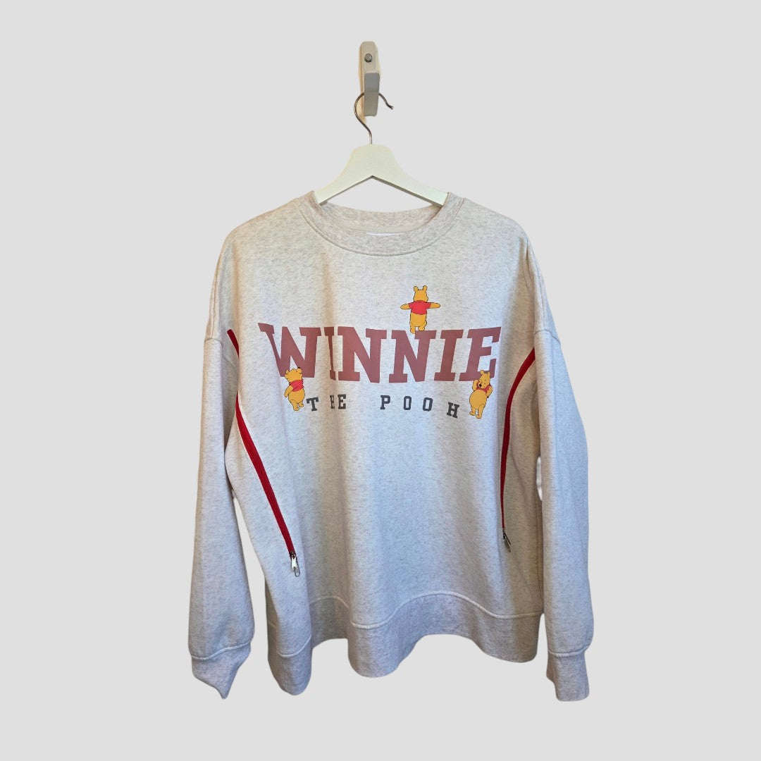 Upcycled Breastfeeding (Nursing) & Pumping Beige Winnie the Pooh sweatshirt XL (UK18/20) (100649) in beige with Winnie the Pooh lettering, character graphics, and side zippers for nursing access.